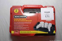 Front view of factory sealed red and black Benchmark bi-metal hole saw set case with 17 pieces for wood and metal cutting.