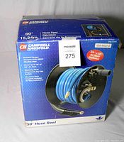 Front view of original retail box showing brand, product name, hose and reel image, and key features like 50-foot hose, 3/8 inch size, and mounting plate.