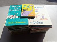 Two stacks of children's books including Dr. Seuss and P.D. Eastman titles