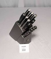 Front view of Henckels knife block filled with knives, scissors, and sharpener.