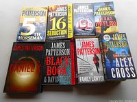 Top view of all 14 books in the lot arranged in two rows showing front covers.