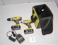 Full kit laid out including drill, impact driver, 2 batteries, charger, and tool bag