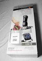 Box front showing Kuraidori Precision Cooker with digital display and 1200W power rating.