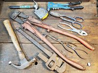Wide view showing all tools laid out on wooden surface revealing sizes and conditions.