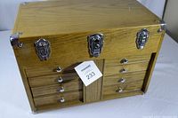 Exterior view of closed toolbox showing oak finish and three chrome latches