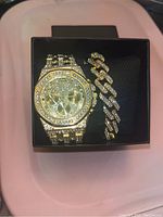 Photo of a watch and matching bracelet set inside a black box on a light background.