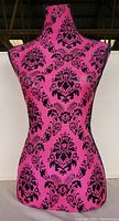 Front view of hot pink ladies display mannequin featuring black damask pattern, showing full torso and neck