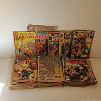 Photo showing the collection of vintage comic books standing upright and stacked. Includes Richie Rich, Annie, Thor, Patsy and Hedy, Fantastic Four, Modok, and Jonah Hex titles visible.