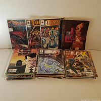 Overview of comic book stacks showing various comic book titles from Image Comics and others, including Spawn, Turok, and I Am Legend hardcover.