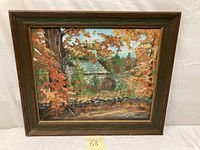 Full view of the framed oil painting showing the fall landscape and home with colorful autumn foliage.