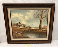 Framed oil painting on canvas showing countryside home, pond, flying ducks and leafless tree under a blue-gray sky.