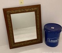 Mirror angled showing the full oak wood outer frame and ornate gilt inner border.