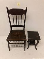 Full front view showing the antique spindle back chair with missing spindles and the small end table beside it.