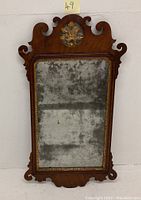 Full view of the antique Queen Anne style mirror showing walnut wood frame and aged desilvered glass.