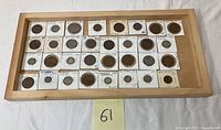 Coins arranged in wooden tray (tray not included) with cardboard holders labeled with year and denomination.