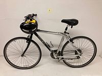 Side view of the Trek 7000 bike, showing full frame, saddle, tires, and helmet attached on handlebar.