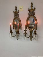 Front view of both sconces mounted side by side showing overall design and mirror backplates.