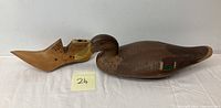 View of the wooden shoe mold next to the mallard decoy showing both items.