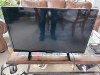Front view of the 32-inch Westinghouse smart TV on a wooden table.