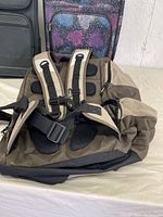 View of the brown and beige backpack showing padded back and adjustable straps.