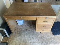 Front view of oak desk showing top, drawers, and base