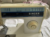 Singer sewing machine model 3317C showing electronic control panel and stitch options.