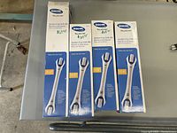 Four boxed Invacare suction cup grab bars on a gray surface. Three are labeled 17.5 inches, one labeled 21.5 inches.