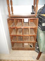 Front view of the handmade rustic wooden shelving showing 12 compartments arranged in 3 rows and 4 columns, with rustic finish and signs of wear.