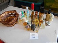 Basket emptied with all perfume bottles arranged on the table