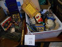 Boxlot of various vintage collectible items including boxed figurines, celluloid pens, and cleaning kits in a box with some other small items.
