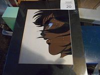 Full view of original production cel artwork mounted on black backing, showing side profile of Japanese anime male character.