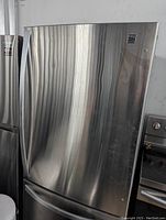 Closed stainless steel single door refrigerator with bottom freezer drawer