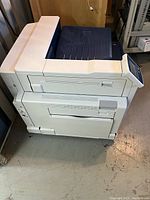 Left-side view of Xerox Phaser 7800DN printer on concrete floor.