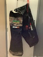 Two heavy duty duffle bags side by side including Primos IClub XXL with camo print and Double Bull black bag with external zippered pocket.