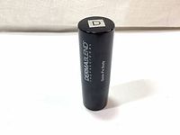 Black cylindrical foundation stick with 'DermaBlend Professional Quick-Fix Body' printed on the side, upright on a white surface.