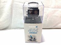 Front view of Safari 3 4K WiFi Action Camera in clear waterproof plastic case with base showing 4K, 60fps+WiFi branding.