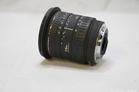 Side view of Sigma 17-35mm lens showing focus and zoom rings with focal length and aperture markings.