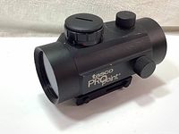 Front side view of Tasco ProPoint Red Dot Sight showing logo and adjustment knob caps.