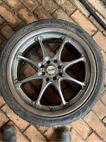 Single Advanti Racing alloy wheel with mounted tire on brick floor