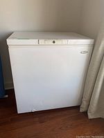 Full view of the white Woods brand chest freezer, showing front and part of the top with lock.