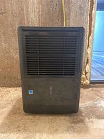 Front view of black Danby dehumidifier showing ventilation grill and water level indicator.