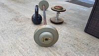 Top and side view showing kettlebell, barbell, and dumbbells on concrete floor.