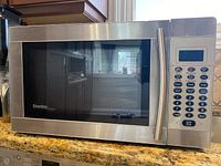 Front view of the Danby stainless steel microwave oven showing door and control panel.