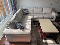 L-shaped sectional sofa front-left view with coffee table