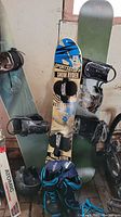 Overview of three snowboards including Burton, SportsStuff Snow Ryder, Prime, a pair of Firefly snowboard boots and Atomic skis