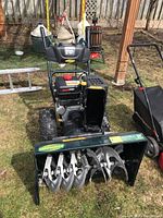 Front view showing 30" auger housing, serrated auger blades and chute outlet