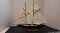 Front side view of the gaff rigged top masted schooner model ship showing the sails, masts, and hull in detail.