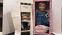 Mrs Beasley doll in original box with pink floral design, visible face and blue polka dot dress.