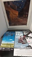 Photo showing two signed theatre posters: 'Waiting for Godot' and 'My Fair Lady'