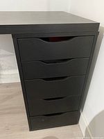 Close-up of the 5-drawer unit with cutout handles in black finish.